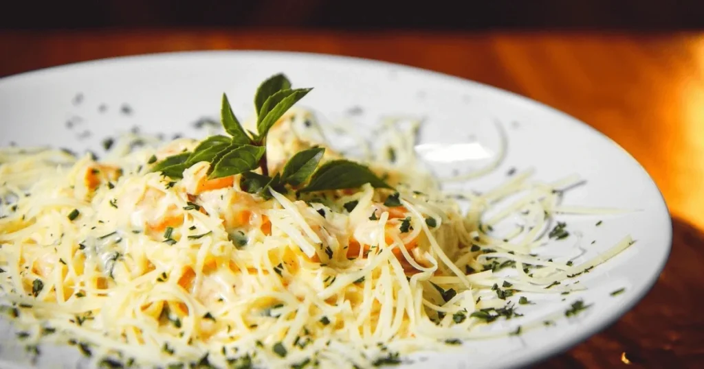 Plate of Barilla Protein Pasta with fresh vegetables and sauce, showcasing a healthy, protein-packed meal option
