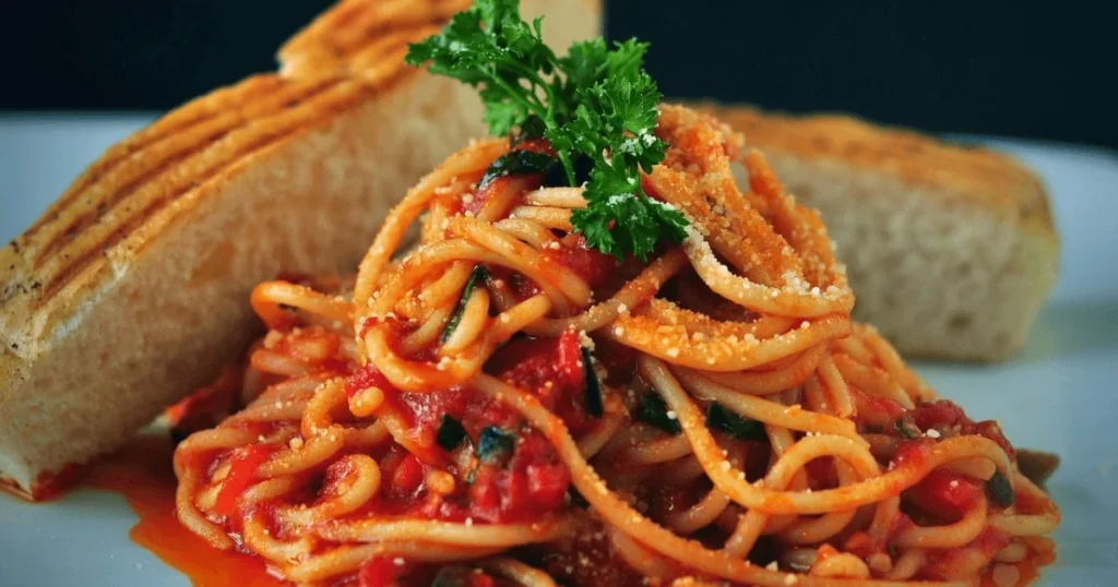 A Plate of Mafaldine Pasta with Rich Tomato Sauce and Fresh Basil