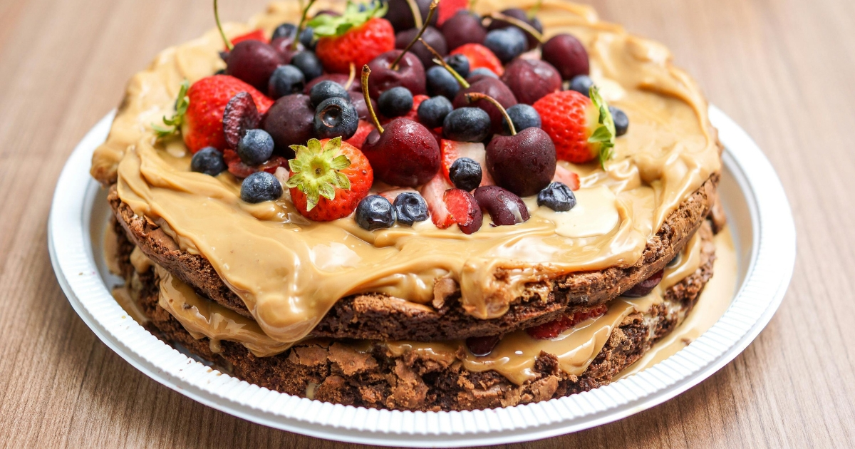 Close-up of a homemade chocolate cake with chocolate glaze and raspberries