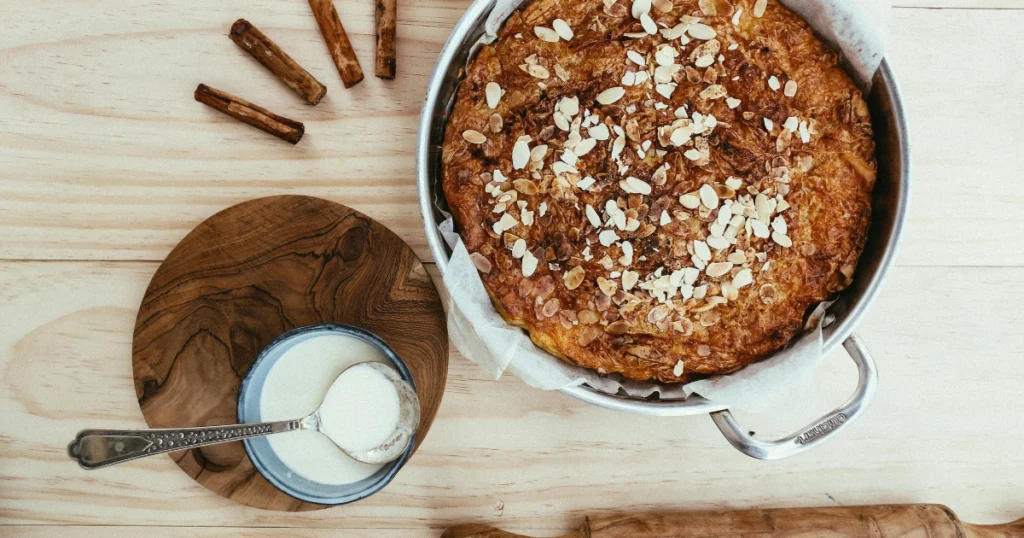 freshly baked Irish apple cake with powdered sugar and whipped cream