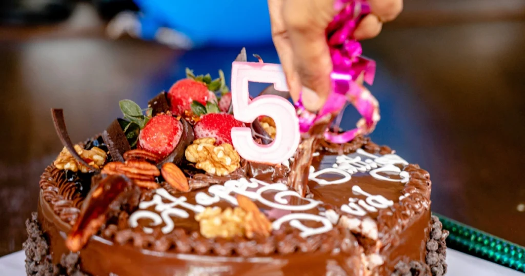 soft moist birthday cake slice with buttercream frosting and sprinkles
