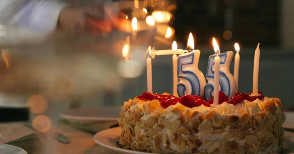 decorating birthday cake with buttercream frosting and sprinkles