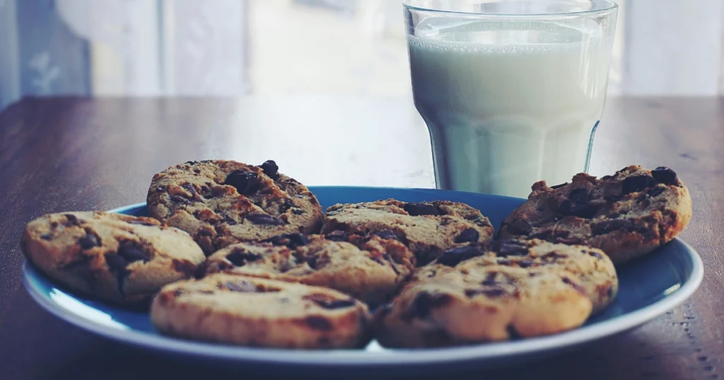 Freshly made no bake cookies cooling on a baking sheet lined with parchment paper.