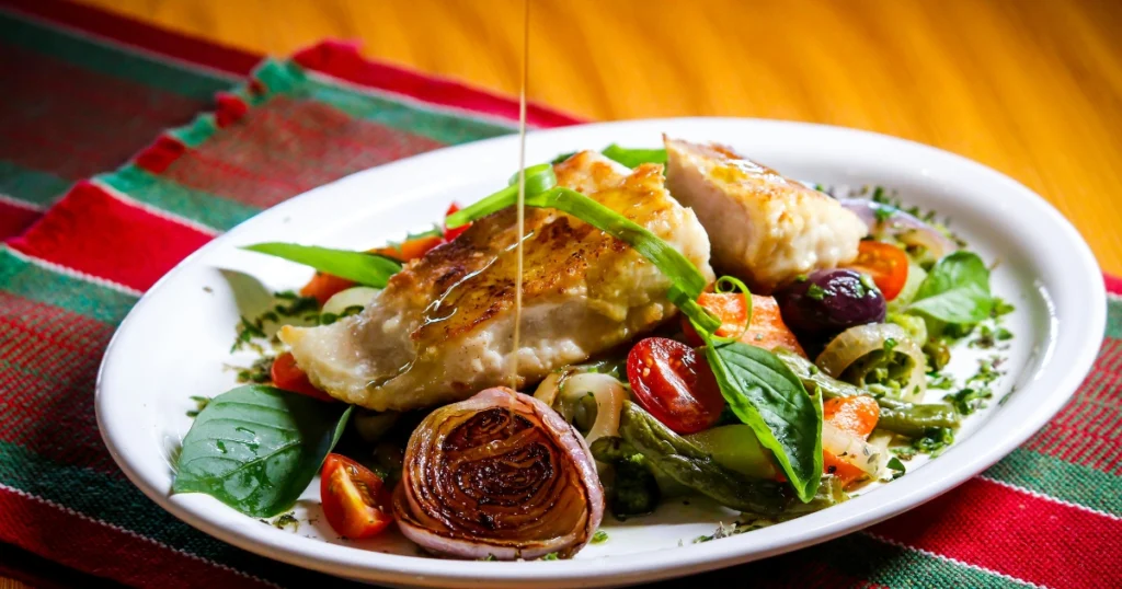 Meal prep containers filled with grilled chicken tenders, rice, and vegetables.