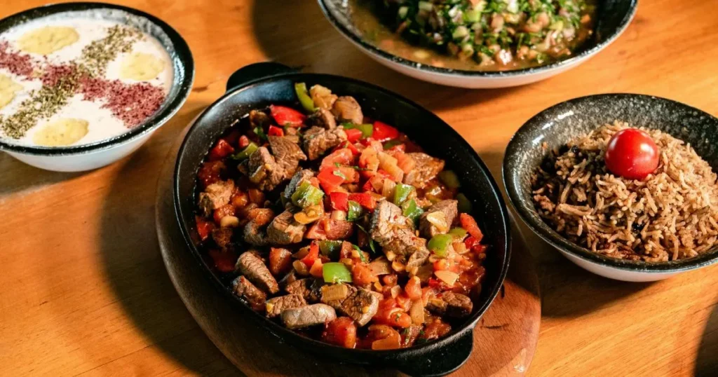 Clock showing 30 minutes with a plated beef tips and rice meal.