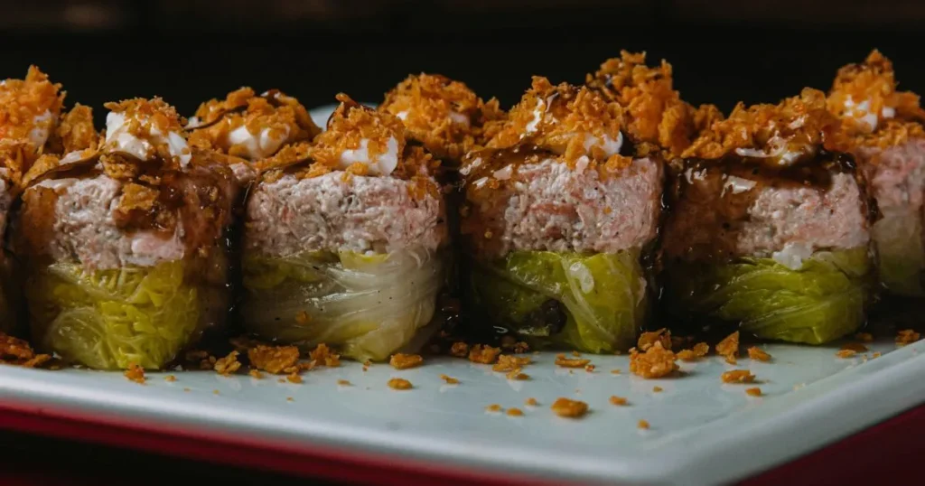 Close-up detail of beef rolls showing enoki mushrooms inside and caramelized edges.