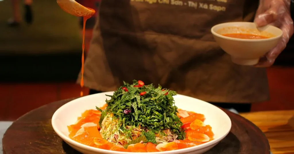 Peanut sauce being drizzled over noodles, showing its rich texture and glossy finish.