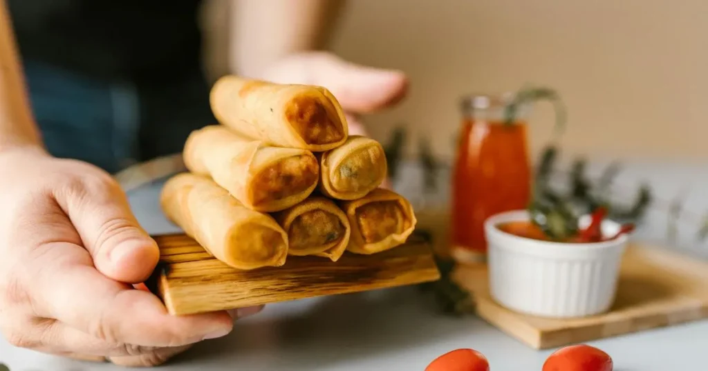 Fresh Vietnamese spring rolls arranged neatly with a dipping bowl of peanut sauce.