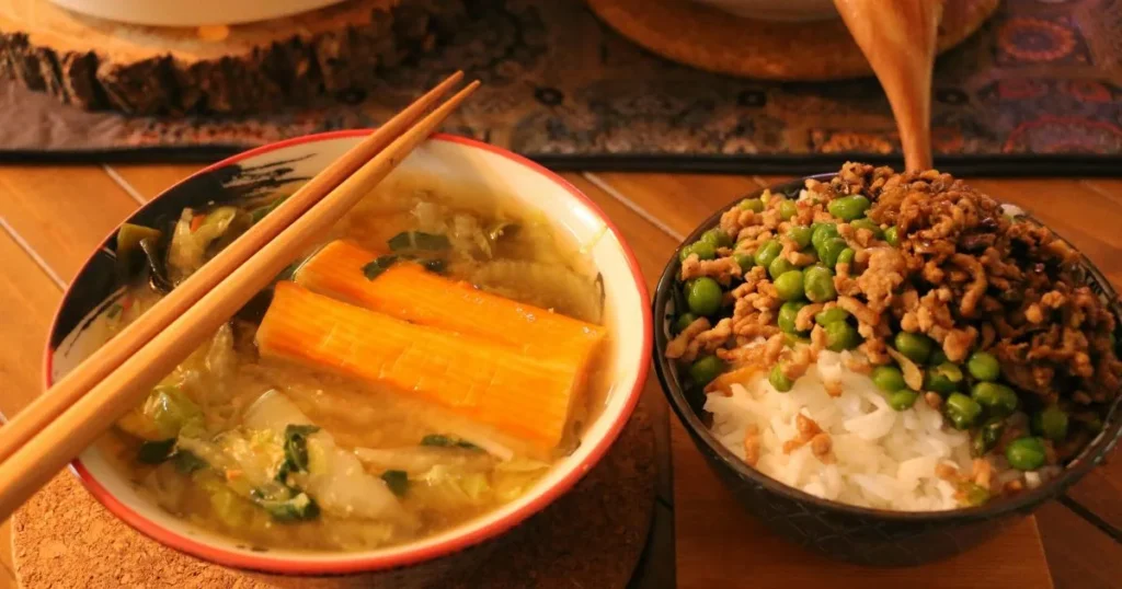 Restaurant-style sizzling rice soup with crispy rice, chicken, vegetables, and steaming broth in a white bowl.