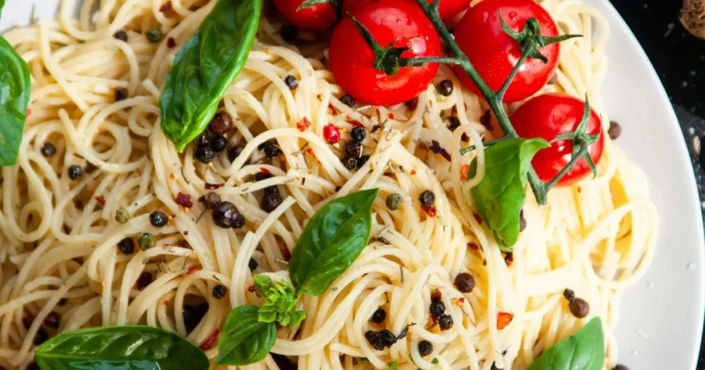 Pasta served in a bowl with parmesan and herbs.