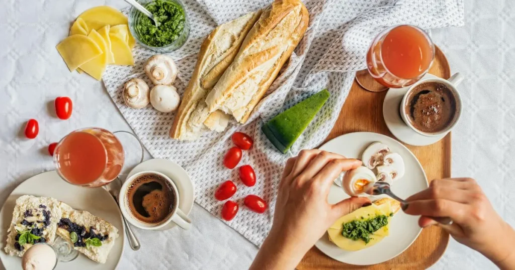 Italian breakfast pastries served with espresso, fresh fruit, and honey on a rustic wooden table.