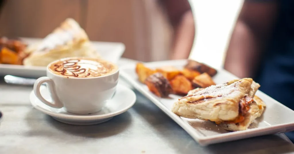 Rustic Spanish breakfast with toasted bread rubbed with tomato, drizzled olive oil, and topped with eggs on a wooden table.