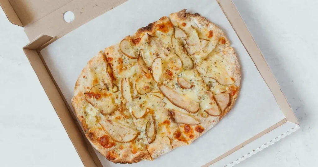 Cheesy school breakfast pizza fresh from the oven with crispy golden edges.