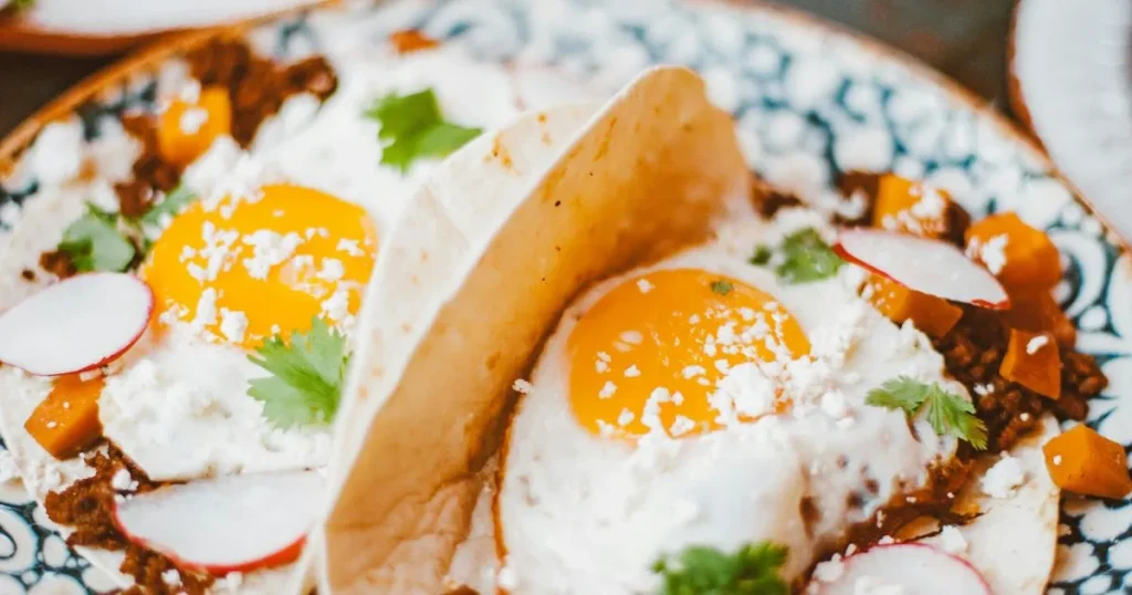 Traditional Mexican chilaquiles served in a rustic bowl with fresh garnishes.
