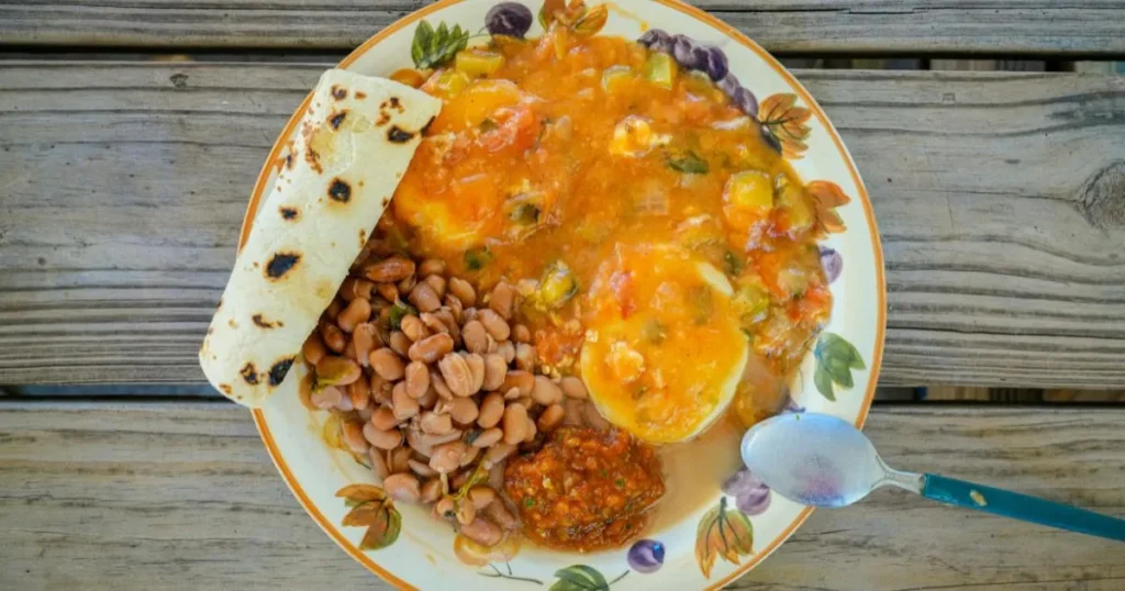Brunch table featuring a large platter of chilaquiles with fresh toppings.