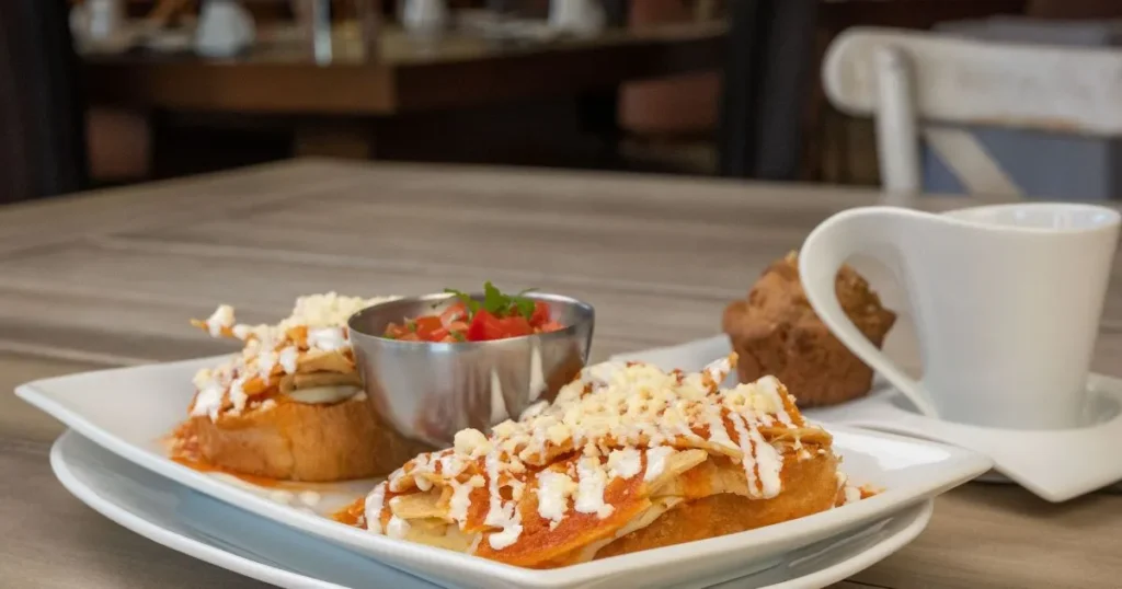 Close-up of authentic Mexican chilaquiles topped with eggs, cheese, and cilantro.